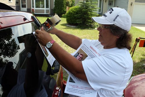Tracey Grand assisting in the search for Thelma Krull. She is plastering posters all over the place, including the back of her car. BORIS MINKEVICH/WINNIPEG FREE PRESS July 13, 2015