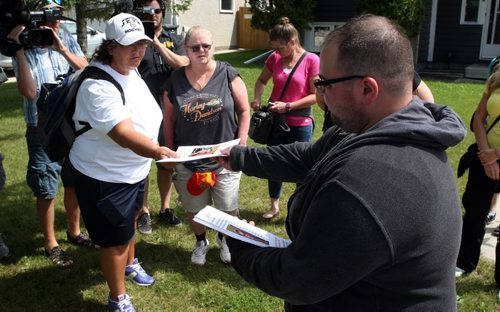 Right, Robert Krull, son of Thelma Krull, missing since yesterday in East Kildonan hands out posters and flyers to search party at noon. BORIS MINKEVICH/WINNIPEG FREE PRESS July 13, 2015