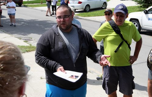 Middle, Robert Krull, son of Thelma Krull, missing since yesterday in East Kildonan hands out posters and flyers to search party at noon. BORIS MINKEVICH/WINNIPEG FREE PRESS July 13, 2015