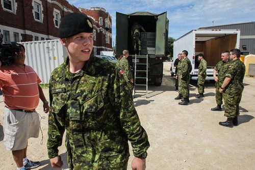 Keith Griffith, 19, a reservist at Minto Armoury helps pack up equipment for the nine hour trip to Prince Albert, Saskatchewan. Approximately 35 Canadian Forces reservists from 38 Canadian Brigade Group shipped off to Prince Albert, Sask. Monday, where they will receive a one-day crash course in firefighting before tackling the real thing on the ground. 150713 - Monday, July 13, 2015 -  MIKE DEAL / WINNIPEG FREE PRESS