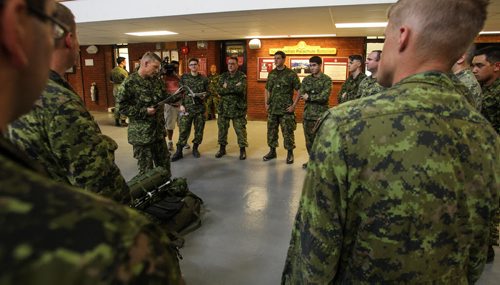Getting ready at Minto Armoury reservists go through a briefing before leaving for on the nine hour trip to Prince Albert, Saskatchewan. Approximately 35 Canadian Forces reservists from 38 Canadian Brigade Group shipped off to Prince Albert, Sask. Monday, where they will receive a one-day crash course in firefighting before tackling the real thing on the ground. 150713 - Monday, July 13, 2015 -  MIKE DEAL / WINNIPEG FREE PRESS