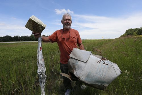 Bill Fisher, along the Perimeter Highway near Brady Rd. with some of the items in the ditch. He lives nearby. Gord Sinclair story. Wayne Glowacki / Winnipeg Free Press July 13 2015