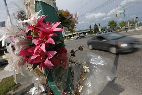 July 12, 2015 - 150712  -  On Monday, July 13, 2015 dead and artificial flowers hang from this lamp post on Keewatin at Burrows where Gloria Davey was killed when she was hit by a city bus.  John Woods / Winnipeg Free Press