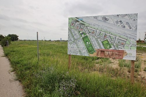 Large development signs dot the weed filled Fort Rouge Yards, a barren 2km stretch of land north of Jubilee running parallel to the Southwest Rapid Transit Corridor. 150714 July 14, 2015 MIKE DEAL / WINNIPEG FREE PRESS