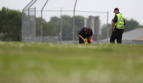 A Police officer takes a photo of a suspicious  item near Kimberly hill where members of the police and cadet units  search for missing women Thelma Krull in the area around Valley Gardens CC Tuesday.  July 14,, 2015 Ruth Bonneville / Winnipeg Free Press