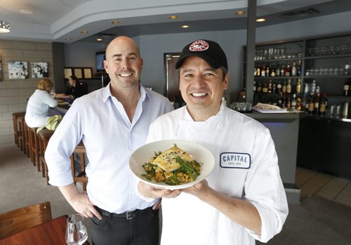 Restaurant Review . Capital Grill and Bar co-owners at right, Chef Wayne Martin holds the Pan Roasted Halibut and Greg Gunnarson.    Marion Warhaft  story. Wayne Glowacki / Winnipeg Free Press July 14 2015