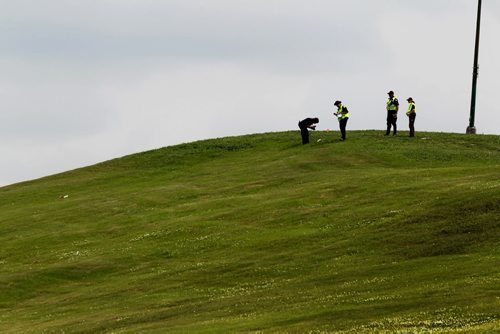 A Police officer takes a photo of a suspicious  item  at the top of Kimberly hill where members of the police and cadet units  search for missing women Thelma Krull in the area around Valley Gardens CC Tuesday.  July 14,, 2015 Ruth Bonneville / Winnipeg Free Press