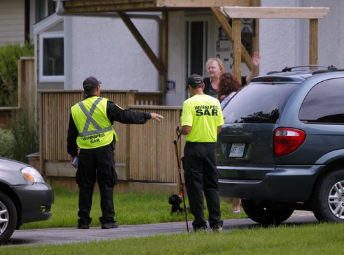 Officers and search and rescue volunteers go door to door looking for clues in the neighbourhoods near Kimberly Civic Park. Photos taken on Green Valley Bay. Search for missing Thelma Krull. BORIS MINKEVICH/WINNIPEG FREE PRESS July 14, 2015