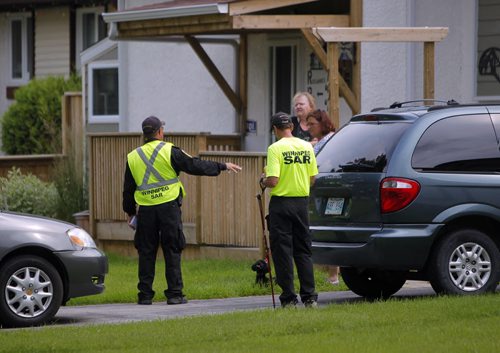 Officers and search and rescue volunteers go door to door looking for clues in the neighbourhoods near Kimberly Civic Park. Photos taken on Green Valley Bay. Search for missing Thelma Krull. BORIS MINKEVICH/WINNIPEG FREE PRESS July 14, 2015