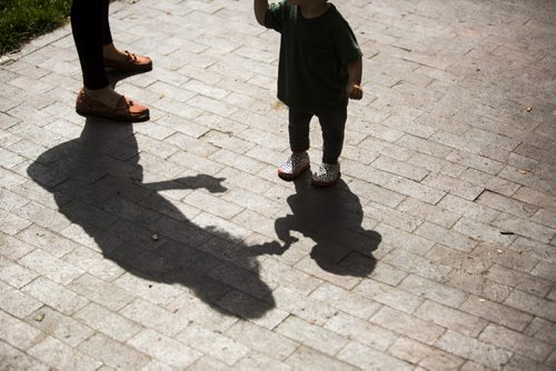 Renée Struthers hands her 13-month-old son, Monty Kendall, a bit of sandwich at the Winnipeg Fringe Festival kick-off at the Old Market Square in Winnipeg on Wednesday, July 15, 2015. Mikaela MacKenzie / Winnipeg Free Press