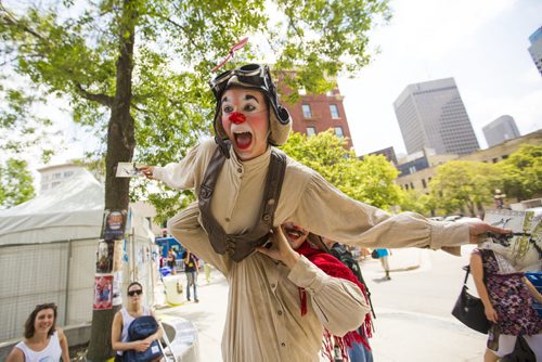 Amica Hunter flies on David Cantor's shoulders, handing out handbills for their show Beau & Aero, at the Winnipeg Fringe Festival kick-off at the Old Market Square in Winnipeg on Wednesday, July 15, 2015.   Mikaela MacKenzie / Winnipeg Free Press
