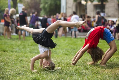 Peyton March, eight-year-old member of the Children of Vaudeville, does a trick at the Winnipeg Fringe Festival kick-off at the Old Market Square in Winnipeg on Wednesday, July 15, 2015.   Mikaela MacKenzie / Winnipeg Free Press