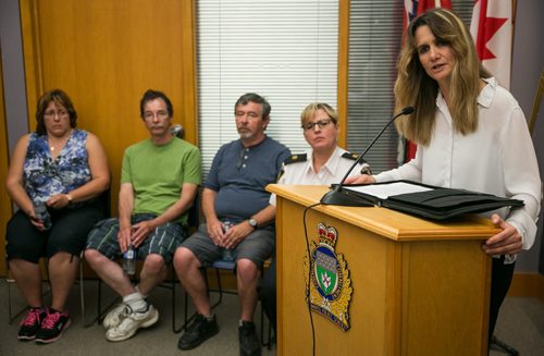 Det.-Sgt. Shaunna Neufeld of Winnipeg Police Service missing persons unit speaks at a press conference on missing 57-year-old Thelma Krull, with her husband Robert Krull, Thelma's brother-in-law Jim Krull (middle) and sister-in-law Lynda Stelmach (left). Thelma Krull was last seen early morning July 11, 2015 in the Harbourview South.  July 15, 2015 - MELISSA TAIT / WINNIPEG FREE PRESS