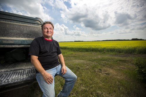 Doug Chorney, East Selkirk farmer, by his canola fields on Wednesday, July 15, 2015.  The haze has created optimal conditions for growing, and Manitoba is looking forward to a number harvest this year.   Mikaela MacKenzie / Winnipeg Free Press