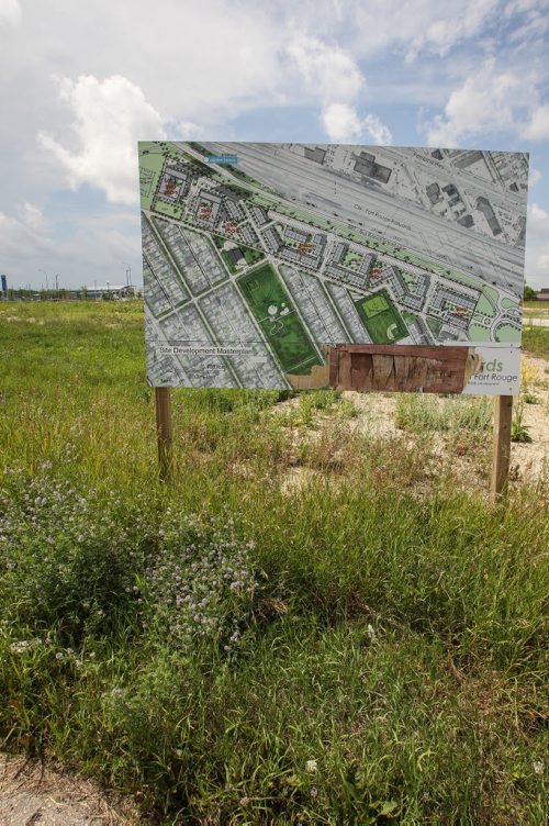 Large development signs dot the weed filled Fort Rouge Yards, a barren 2km stretch of land north of Jubilee running parallel to the Southwest Rapid Transit Corridor.  150715 - Wednesday, July 15, 2015 -  MIKE DEAL / WINNIPEG FREE PRESS