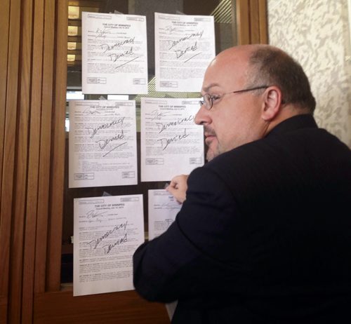 An angry Russ Wyatt tapes his 20 rejected amendments to the pedestrian-and-cycling strategy on Mayor Brian Bowmans door Wednesday, July 15, 2015   Kristin Annable / Winnipeg Free Press