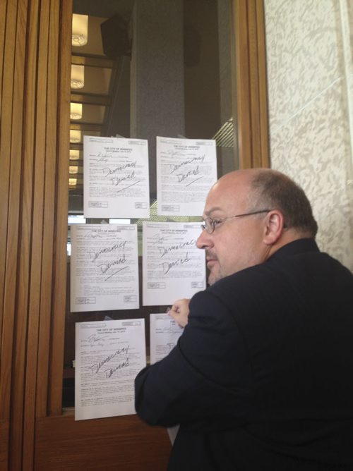 ORIGINAL FILE.  An angry Russ Wyatt tapes his 20 rejected amendments to the pedestrian-and-cycling strategy on Mayor Brian Bowmans door Wednesday, July 15, 2015  Kristin Annable / Winnipeg Free Press