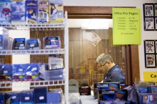 Rick Moreira peruses the hockey cards at Lower Level Sports Cards and Collectibles in Elmwood on Thursday, July 16, 2015.  Mikaela MacKenzie / Winnipeg Free Press