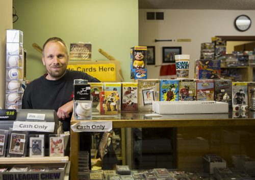 Mike Bergmann, owner of Lower Level Sports Cards and Collectibles, in his sports card shop in Elmwood on Thursday, July 16, 2015.  Mikaela MacKenzie / Winnipeg Free Press
