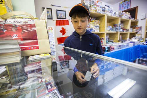 Mathiew Ferrand, 10, looks at the cards at Lower Level Sports Cards and Collectibles in Elmwood on Thursday, July 16, 2015.  Mikaela MacKenzie / Winnipeg Free Press