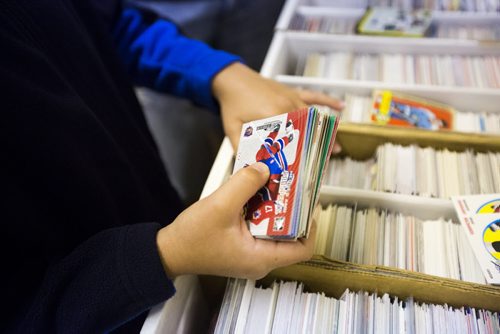 Mathiew Ferrand, 10, looks at hockey cards at Lower Level Sports Cards and Collectibles in Elmwood on Thursday, July 16, 2015.  Mikaela MacKenzie / Winnipeg Free Press