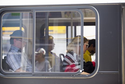 Passengers ride a bus on Portage Avenue in Winnipeg on Thursday, July 16, 2015.  As some buses don't have air conditioning, many are complaining of the heat. Mikaela MacKenzie / Winnipeg Free Press