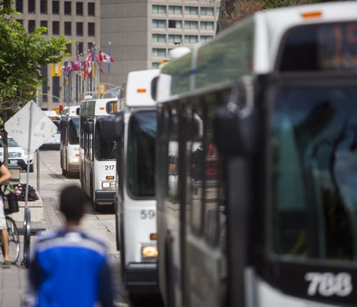 Buses come and go on Portage Avenue in Winnipeg on Thursday, July 16, 2015.  As some buses don't have air conditioning, many are complaining of the heat. Mikaela MacKenzie / Winnipeg Free Press