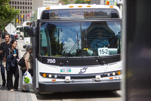 Passengers board a bus on Portage Avenue in Winnipeg on Thursday, July 16, 2015.  As some buses don't have air conditioning, many are complaining of the heat. Mikaela MacKenzie / Winnipeg Free Press