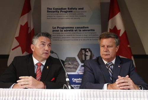 At left, James Bezan, Parliamentary Secretary to the Minister of National Defence and the MP for Selkirk  Interlake, and Lawrence Toet, the MP for ElmwoodTranscona,  announced four innovative projects  to be supported through the Canadian Safety and Security Program to improve prevention and response to natural disasters, such as flooding, and public health emergencies across Canada. The event was held in the National Microbiology Laboratory Theatre on Friday.  Bruce Owen story Wayne Glowacki / Winnipeg Free Press July 17 2015