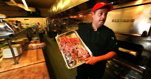 Bill Georgakopoulos, Chef at Rae and Jerry's Restraunt moves a tray of beef steak through the dining icon's kittchen. See Martin Cash story re: rising (beef) food costs. July 17, 2015 - (Phil Hossack / Winnipeg Free Press)