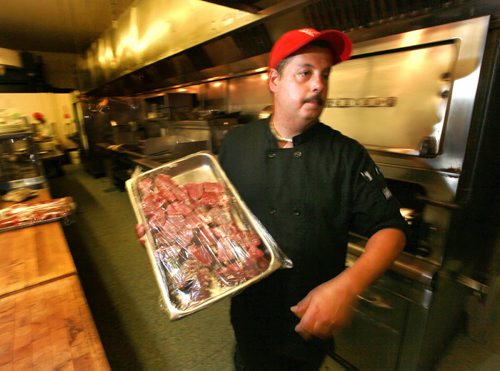 Bill Georgakopoulos, Chef at Rae and Jerry's Restraunt moves a tray of beef steak through the dining icon's kittchen. See Martin Cash story re: rising (beef) food costs. July 17, 2015 - (Phil Hossack / Winnipeg Free Press)