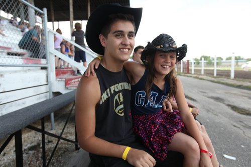 Brett Saindon sits with his little sister Shaelyn  11yrs as they watch the horse races at the Morris Grandstand during the 52nd annual Morris Stampede Friday afternoon.   July 16,, 2015 Ruth Bonneville / Winnipeg Free Press