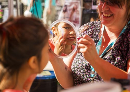 Brooklynn Thomas, 7, takes a look at her face paint at the Fringe Festival in Old Market Square in Winnipeg on Friday, July 17, 2015.   Mikaela MacKenzie / Winnipeg Free Press