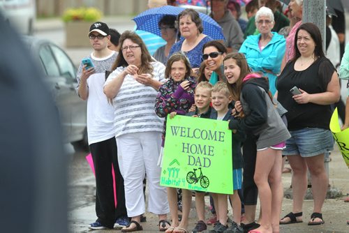 Family and friends wait with anticipation on Nairn Ave. next to Habitat for Humanity build site  for their loved ones to come home after cycling 1,000.00 miles from  Niagara Falls to Winnipeg to raise money for a Habitat. See story.   July 18,, 2015 Ruth Bonneville / Winnipeg Free Press
