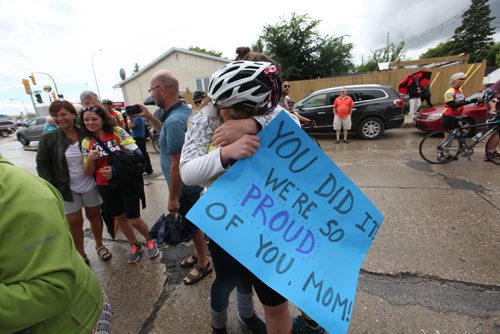 Risa Olekshy gets a grand welcoming from her daughter Tasha after cycling with 48 others from Niagara Falls  1,000 miles home to Wpg over a two-week period all to raise money for a Habitat. See story.   July 18,, 2015 Ruth Bonneville / Winnipeg Free Press