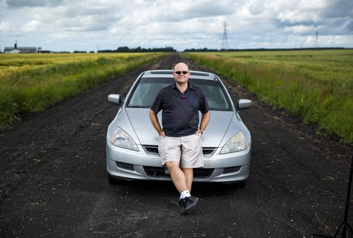 Al Small, Free Press entertainment editor, leans on his trusty road-tripping car just outside of Winnipeg on Saturday, July 18, 2015.   Mikaela MacKenzie / Winnipeg Free Press