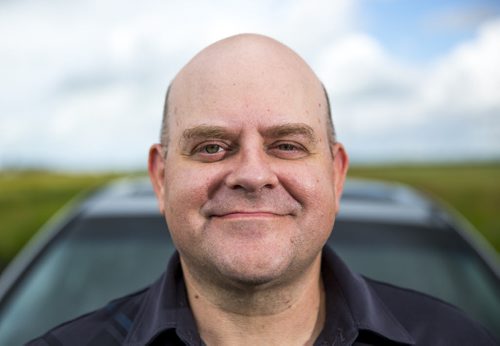 Al Small, Free Press entertainment editor, leans on his trusty road-tripping car just outside of Winnipeg on Saturday, July 18, 2015.   Mikaela MacKenzie / Winnipeg Free Press