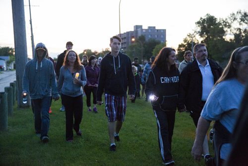 Family, friends, and residents of the community come together for a walk to "light the way" for Thelma on Concordia Avenue in Winnipeg on Saturday, July 18, 2015.   Mikaela MacKenzie / Winnipeg Free Press