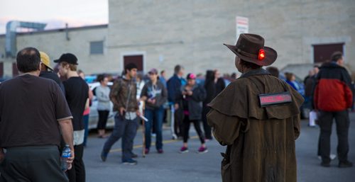 Douglas Sutherland wears a sign on his back as family, friends, and residents of the community gather for a walk to "light the way" for Thelma on Concordia Avenue in Winnipeg on Saturday, July 18, 2015.   Mikaela MacKenzie / Winnipeg Free Press