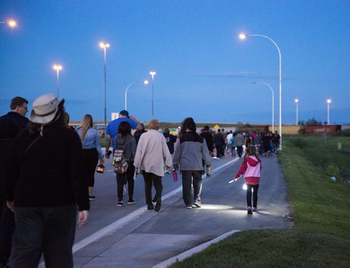 Family, friends, and residents of the community come together for a walk to "light the way" for Thelma on Concordia Avenue in Winnipeg on Saturday, July 18, 2015.   Mikaela MacKenzie / Winnipeg Free Press