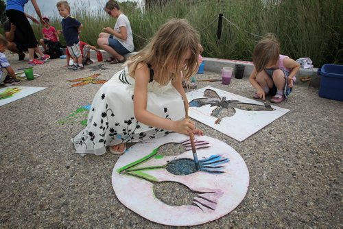 Zinnia O'Leary, 7, paints flowers in the parking lot of the Living Prairie Museum during 9th Annual Monarch Butterfly Festival. 150719 July 19, 2015 MIKE DEAL / WINNIPEG FREE PRESS