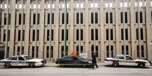 A large truck smashed into five police vehicles, one at at time, that were parked outside the Police Safety Building on Princess Street around 11:00 a.m. Monday morning. July 20, 2015 - MELISSA TAIT / WINNIPEG FREE PRESS