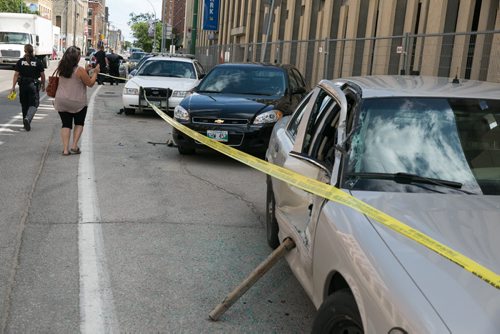 A large truck smashed into five police vehicles, one at at time, that were parked outside the Police Safety Building on Princess Street around 11:00 a.m. Monday morning. July 20, 2015 - MELISSA TAIT / WINNIPEG FREE PRESS
