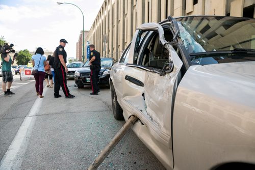 A large truck smashed into five police vehicles, one at at time, that were parked outside the Police Safety Building on Princess Street around 11:00 a.m. Monday morning. July 20, 2015 - MELISSA TAIT / WINNIPEG FREE PRESS