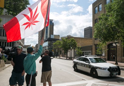 Steven Stairs smokes marijuana outside the Public Safety Building to protest the medical marijuana license requirements.   July 20, 2015 - MELISSA TAIT / WINNIPEG FREE PRESS