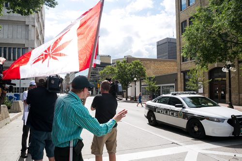 Steven Stairs smokes marijuana outside the Public Safety Building to protest the medical marijuana license requirements.   July 20, 2015 - MELISSA TAIT / WINNIPEG FREE PRESS