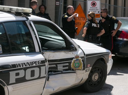 Five parked police vehicles smashed by a large white truck around 11 a.m. Monday morning outside the Public Safety Building. July 20, 2015 - MELISSA TAIT / WINNIPEG FREE PRESS
