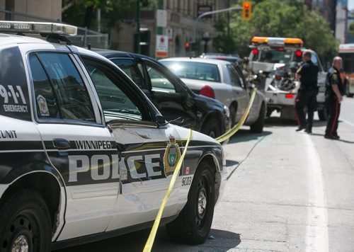 Five parked police vehicles smashed by a large white truck around 11 a.m. Monday morning outside the Public Safety Building. July 20, 2015 - MELISSA TAIT / WINNIPEG FREE PRESS