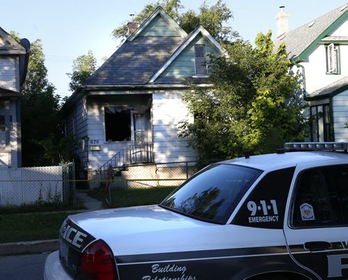 Winnipeg Police hold the scene Tuesday morning of a house fire at  676  Pritchard Ave., the police homicide unit is investigating after a body was removed from the house that burned early Monday. Wayne Glowacki / Winnipeg Free Press July 21 2015 ¤