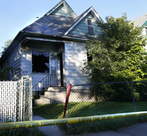Winnipeg Police hold the scene of a house fire Tuesday morning at  676  Pritchard Ave., the police homicide unit is investigating after a body was removed from the house that burned early Monday. Wayne Glowacki / Winnipeg Free Press July 21 2015 ¤
